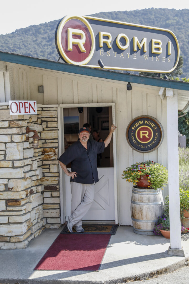 A man standing in front of a restaurant door.